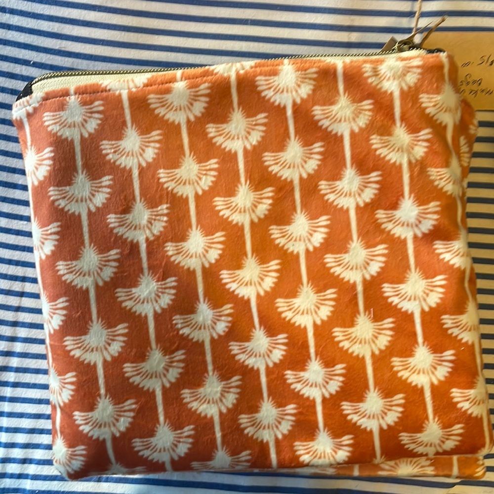 This handmade orange like suede with denim interior bag, dimensions are 9” x 8“.